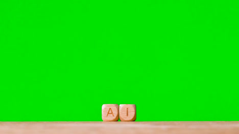 Business-Concept-Wooden-Letter-Cubes-Or-Dice-Spelling-AI-Against-Green-Screen